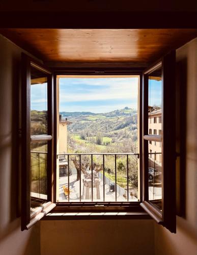 an open window with a view of a city at LocAle Guest House in Pietralunga