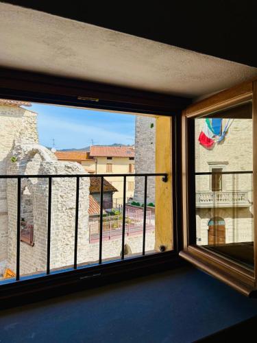 a room with a window with a view of a building at LocAle Guest House in Pietralunga
