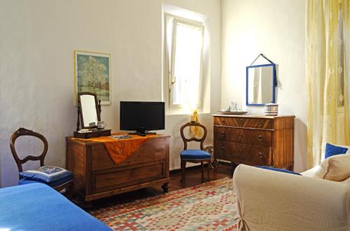 a bedroom with a bed and a dresser with a tv at Cà Morari in Argenta