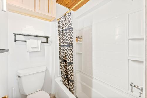 a bathroom with a toilet and a shower at Whitefish Mountain Chalet- Ptarmigan Village with Amenities and Nearby to Whitefish Mountain Resort! in Whitefish