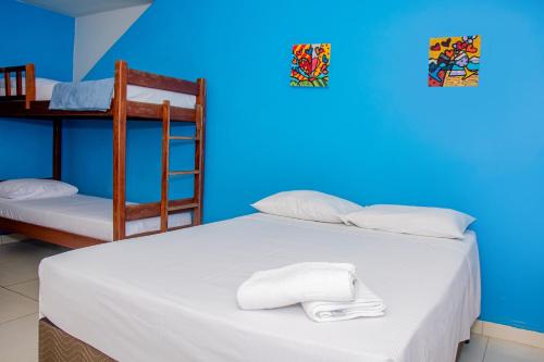a bedroom with a bed with two bunk beds and a ladder at Pousada Flat Castor in Natal