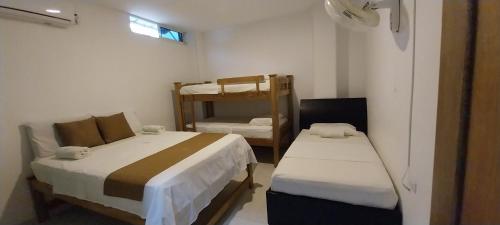 a small room with two beds and a bunk bed at Cabañas Berakah in Coveñitas