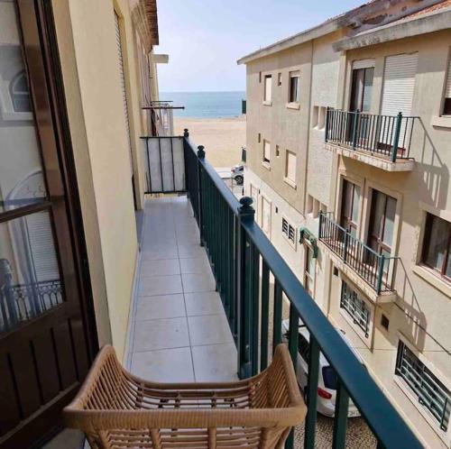 a balcony of a building with a view of the beach at Junto à Praia in Nazaré