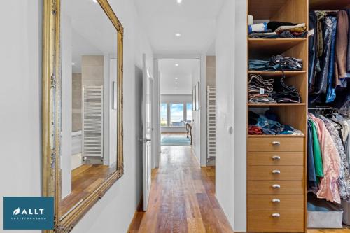 a hallway with a large mirror in a closet at Ocean House in Njarðvík