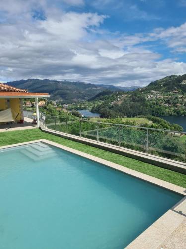 a swimming pool with a view from a house at Casa do Alto in Terras de Bouro