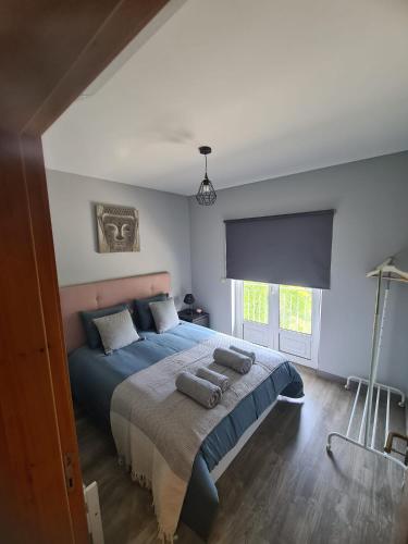 a bedroom with a bed with two pillows on it at Casa do Alto in Terras de Bouro