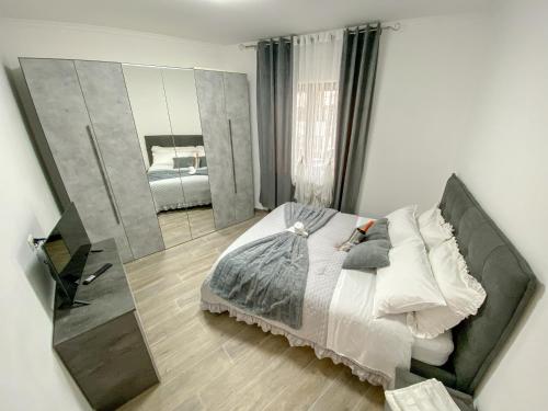a bedroom with a bed and a large mirror at Holiday House 2 in Viterbo