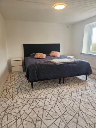 a bedroom with a bed with a geometric carpet at Relax Place in Svalöv