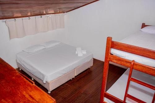a bedroom with two bunk beds and a ladder at Pousada Flat Castor in Natal