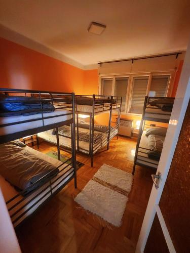 a room with three bunk beds in a room at D&P WELLNESSHÁZ in Dabas