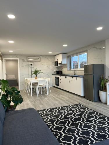 a kitchen and a living room with a table and a kitchen and a kitchen at CANAVESES RIVER HOUSE - ALOJAMENTO RURAL in Marco de Canaveses