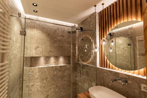 a bathroom with a shower and a toilet and a mirror at Traumhafte und hochwertige Stadtwohnung im Zentrum Augsburgs in Augsburg
