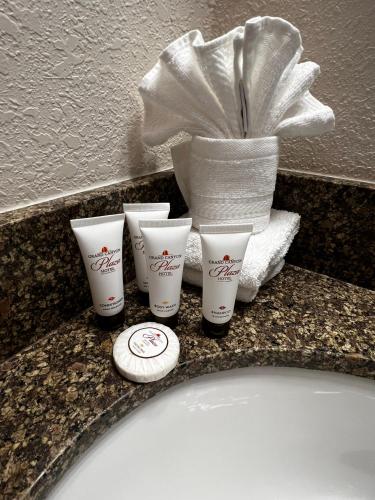 a group of four cups on a bathroom sink at Canyon Plaza Premier Studios and Apts-South Rim in Tusayan
