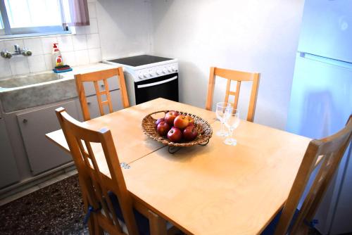 a kitchen with a table with a bowl of fruit on it at Gianna Seaside in Koutsounari