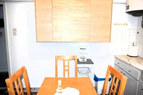 a kitchen with a wooden table and chairs at Gianna Seaside in Koutsounari