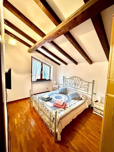 a bedroom with a bed in a room with wooden floors at Villa Iris in Casarza Ligure