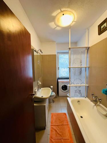 a bathroom with a tub and a sink and a toilet at Villa Iris in Casarza Ligure