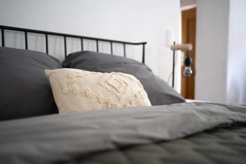 a bed with a pillow on top of it at Ferienwohnung am Siglhof in Samerberg