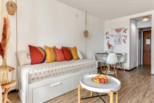 un salon avec un canapé et une table dans l'établissement Locapdagde Plume de Maya Plage Môle Wifi Clim Ménage incl, au Cap d'Agde