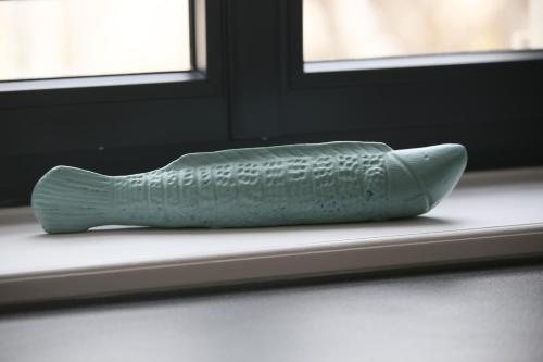 a sculpture of a fish sitting on a window sill at Villa Joséphine 4-11 personnes in Asnelles