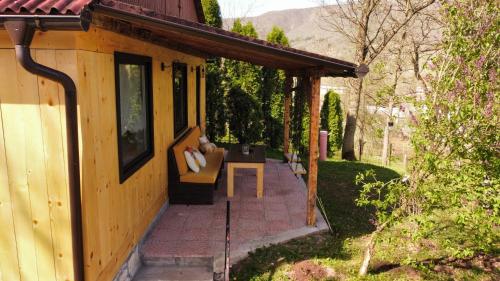 a porch of a house with a couch on it at Sole Tiny House in Šipovo
