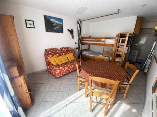 a room with a table and a couch and a bed at Résidence Neouvielle - Studio dans le centre de Barèges proche du jardin MAE-5411 in Barèges