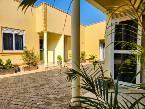a yellow building with a pillar and a courtyard at Luxury Suites in Seeta
