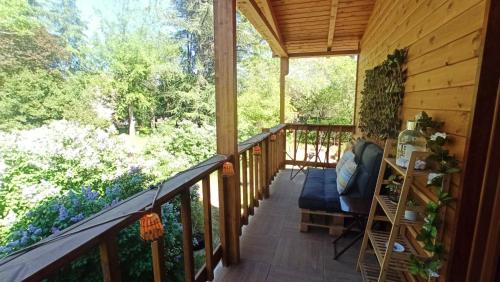 a porch of a cabin with a view of the woods at Habitación simple con baño in Guadarrama