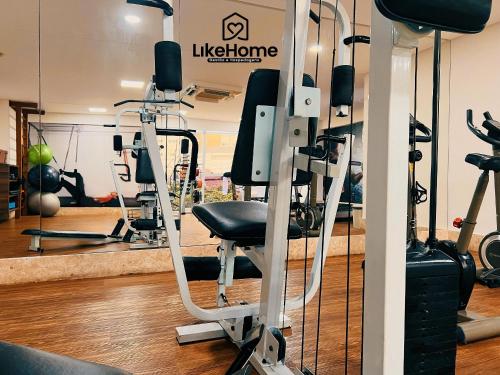 a gym with tread machines and a black chair at Tambaú Flex Home - LikeHome in Tambaú