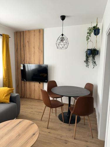 a living room with a table and chairs at Moms house 2 in Golubac