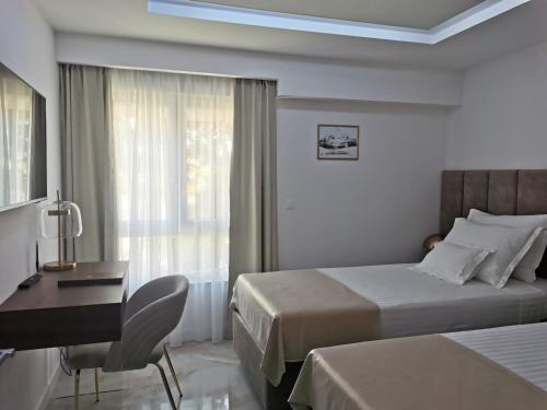 a hotel room with two beds and a desk at Luxury apartment Galant 1 in Split