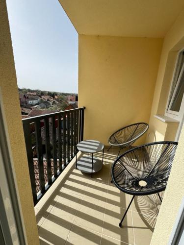 a balcony with two chairs and a table at Moms house 2 in Golubac