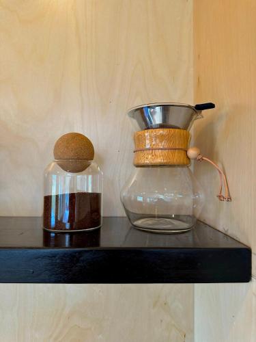 a glass vase and a bowl on a shelf at Asheville River Cabins in Arden