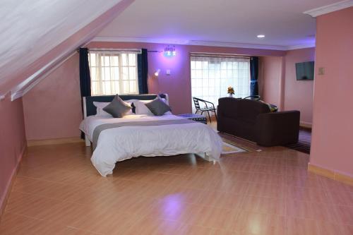 um quarto com uma cama grande e um quarto roxo em Kijabe Sunset View Guesthouse em Kijabe
