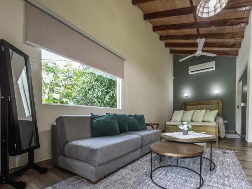 a living room with a couch and a tv at Quinta La Paloma in Itauguá