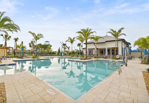 a pool at a resort with palm trees at Wonderful Villas 18 Minutes away from Disney! in Kissimmee