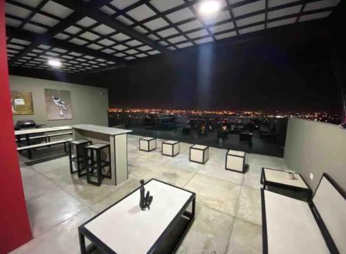 a room with tables and chairs and a view of a city at Santa Lucia Lofts Duplex in Cali