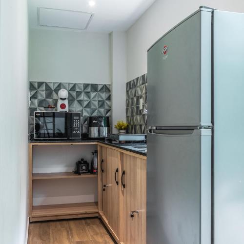 a kitchen with a stainless steel refrigerator at Quinta La Paloma in Itauguá