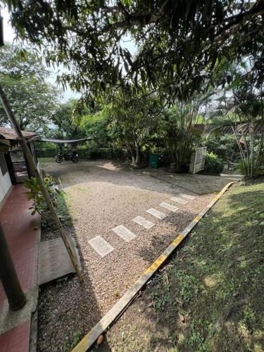 a yard with a playground with a swing at Alojamiento cerca a La Mesa con Piscina in Cachipay
