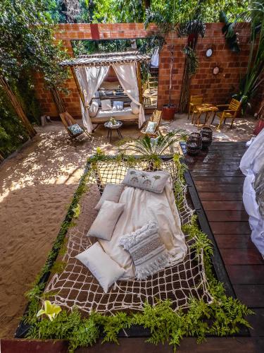 a bed with pillows and blankets on a patio at Quinta La Paloma in Itauguá
