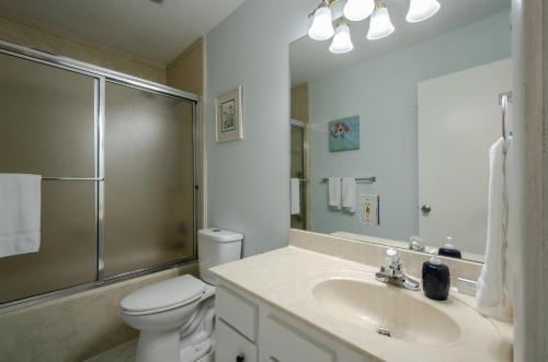 a bathroom with a toilet and a sink and a shower at Dauphin Island in Forney