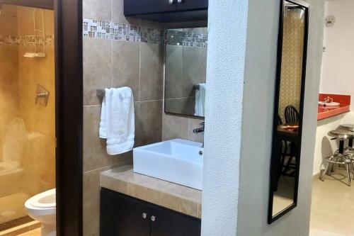 a bathroom with a sink and a toilet at Zely home # 4 in Cancún