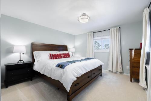 a bedroom with a large bed and a window at Pine Perch ~ Cozy Mountain Cabin w/ Views in Bailey