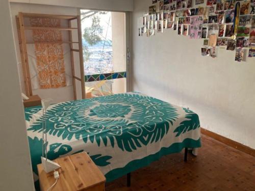 a bedroom with a bed in a room with a window at Maison d'artistes avec vue panoramique sur la baie in Toulon