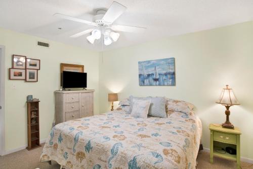 a bedroom with a bed and a ceiling fan at Southern Island Charm in Dauphin Island