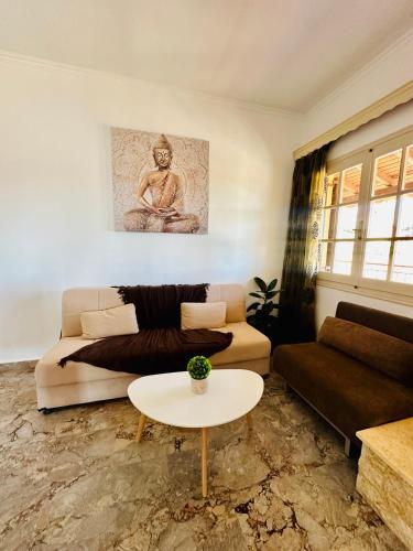 a living room with a couch and a table at Nikos Apartments Corfu in Agios Stefanos