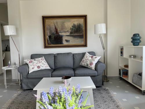 a living room with a couch and a table at Verano Retreat in Chania