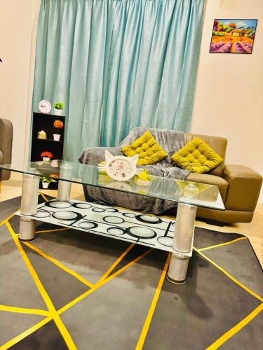 a living room with a couch and a glass table at Sunway /Usj one Residence/ CozyHome/2bed room/2 Bath in Subang Jaya