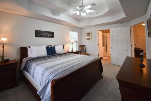a bedroom with a large bed with a ceiling fan at Lakeview Dreams in Young Harris