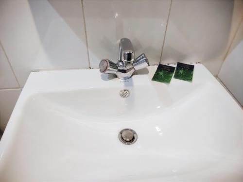 a bathroom sink with a faucet and two cards on it at الغبيشى بلازا in Jeddah